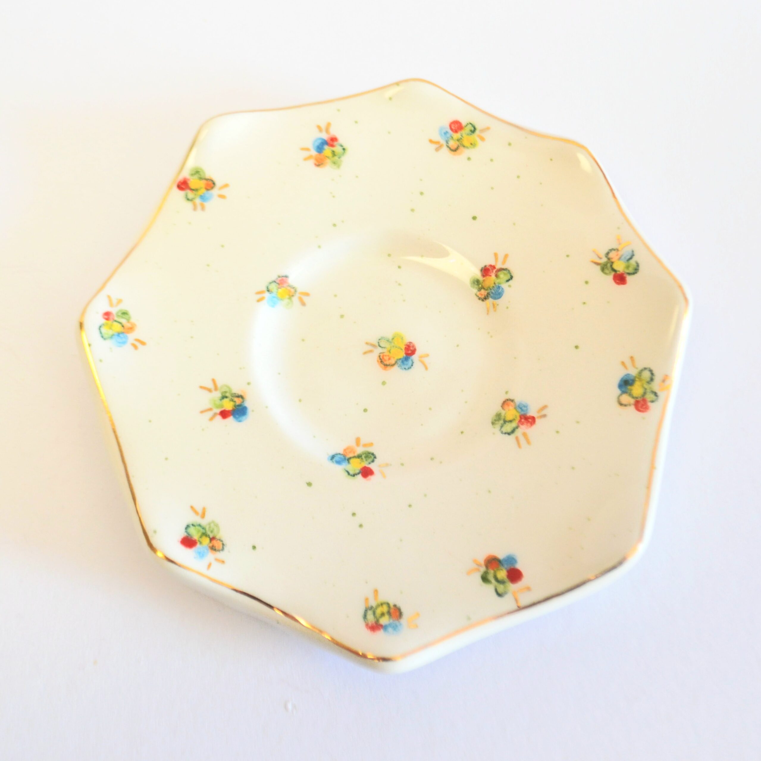 Octagonal plate, painted with colorful small flowers and gold rim.
