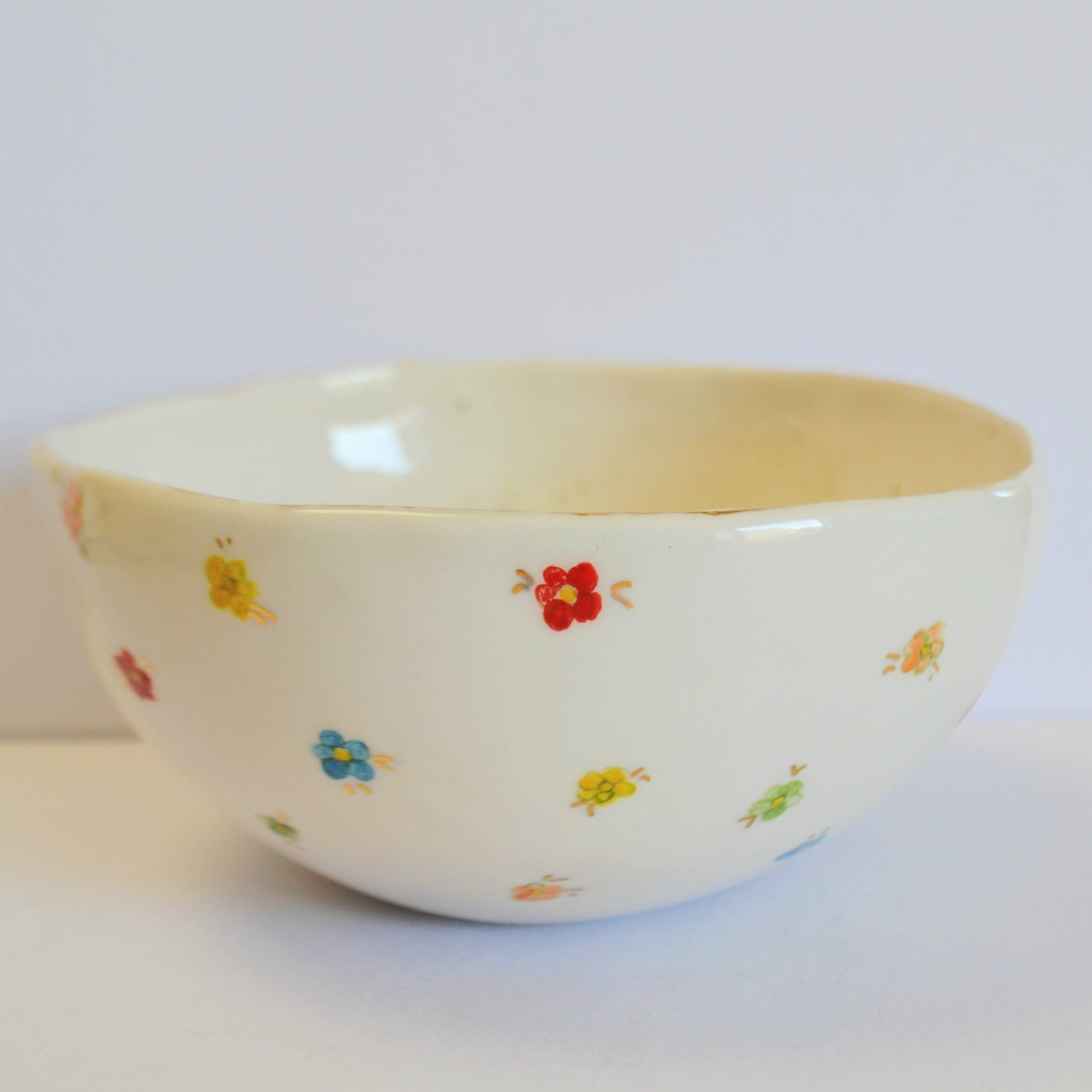 Back of bowl, painted with tiny colorful tiny flowers.